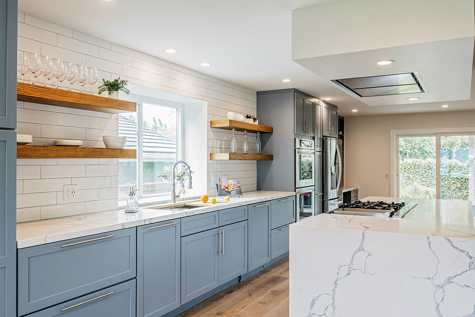 Hopkins kitchen after LIS remodel — blue-gray cabinetry, marble island, subway tile and open wood shelving