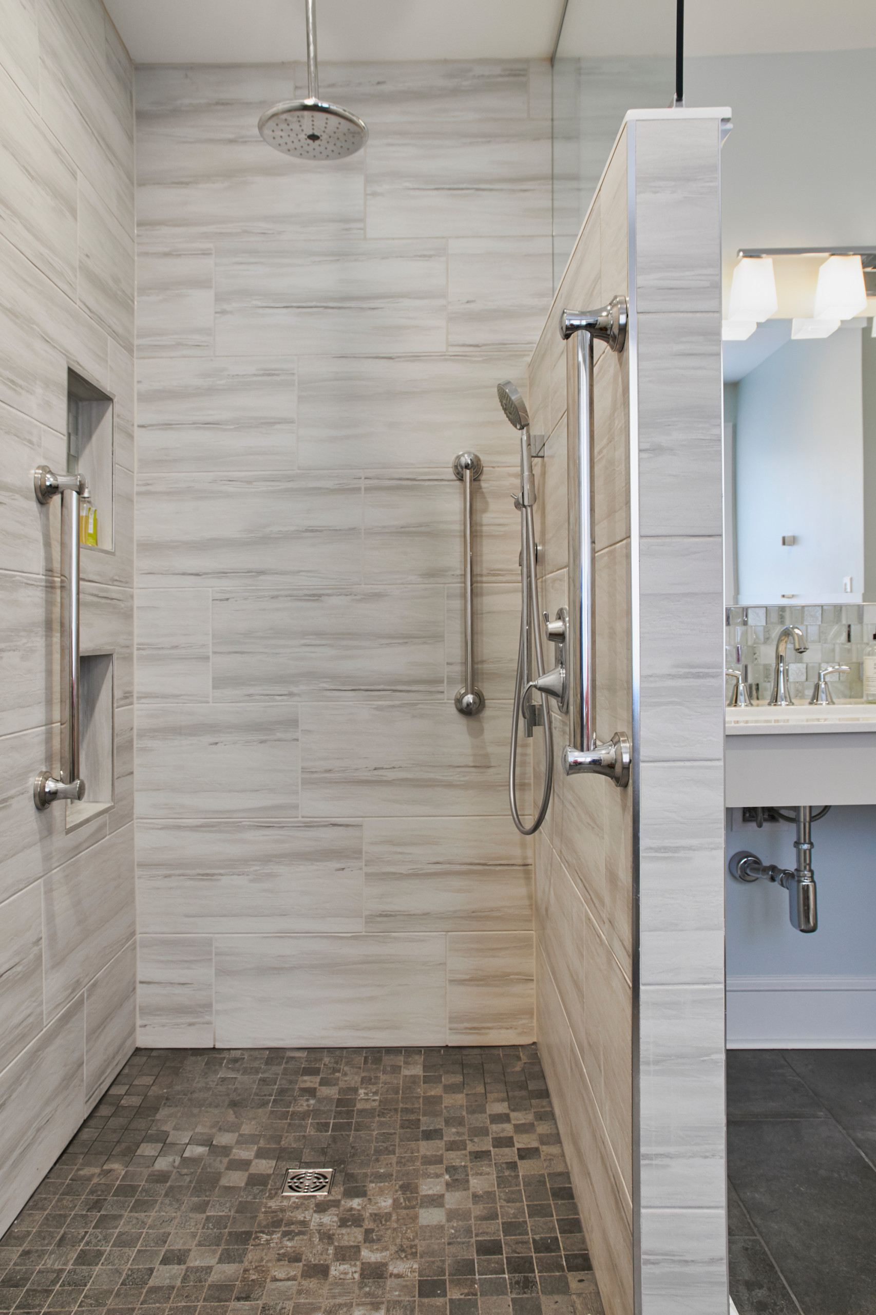 Elegant accessible bathroom with a curbless walk-in shower and integrated grab bars